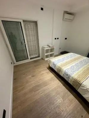a bedroom with a bed and two large windows at Alloggio Roma Appia in Rome