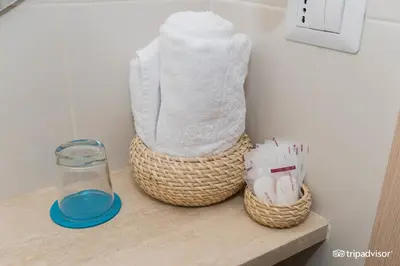 a shelf with two baskets and a bottle of water at Ara Pacis Inn in Rome