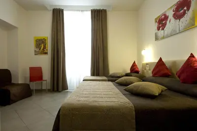 a hotel room with two beds and a window at Ara Pacis Inn in Rome