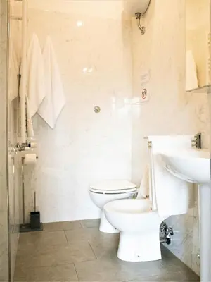a bathroom with a toilet and a sink at B&B Dea Tiburtina in Rome