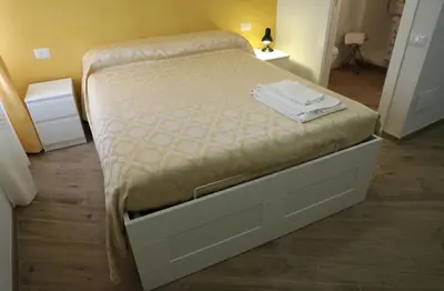 a bedroom with a bed with a large drawer at Affittacamere Arte nei Colori in Rome