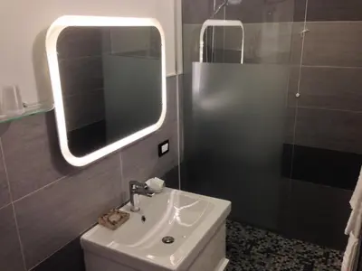 a bathroom with a sink and a mirror at CityLife Rome in Rome