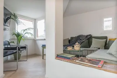 a living room with a couch and a table at GuestHost - Piazza Venezia&Colosseum Loft in Rome