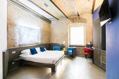 a bedroom with a bed and a table and chairs at Hotel La Rovere in Rome