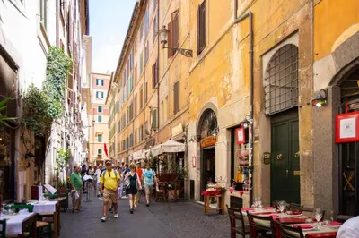 a group of people walking down a street at POP Art B&B in Rome