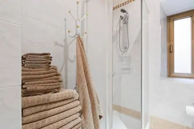 a bathroom with a shower and a pile of towels at Casa Vacanze Risorgimento in Rome