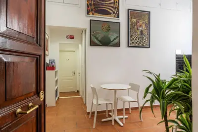 a dining room with a table and chairs at Appartamento Via Genova in Rome