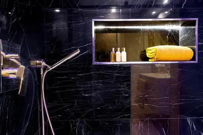 a black bathroom with a shower with a yellow towel at Marvellous apt near Vatican in Rome