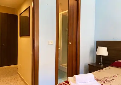 a hotel room with a bed and a mirror at Sweet Dream Roma Termini in Rome