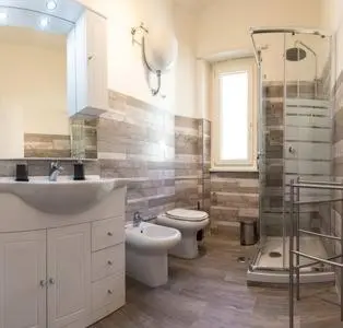 a bathroom with a sink and a toilet and a shower at Romantic & Comfy Apartment Monteverde in Rome