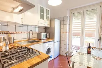 a kitchen with a stove top oven next to a table at Romantic & Comfy Apartment Monteverde in Rome