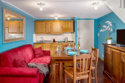 a living room with a red couch and a table at Navona Blue Apartment in Rome