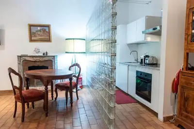 a kitchen with a table and chairs in a room at Monti Bespoke in Rome
