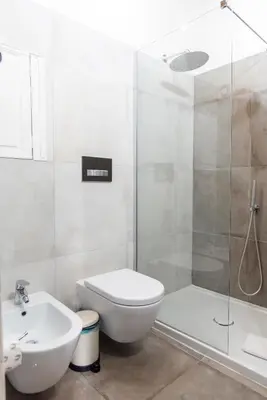 a bathroom with a shower and a toilet and a sink at Monti Bespoke in Rome