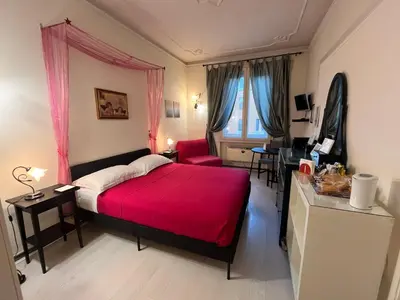 a bedroom with a red bed and a desk at B&B DolceVirginia in Rome