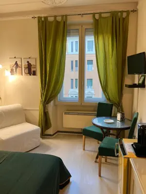 a living room with a couch and a table and a window at B&B DolceVirginia in Rome