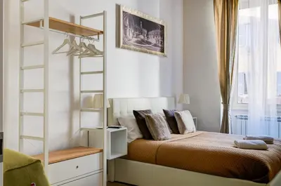 a bedroom with a bed and a book shelf at St. Peter Vatican Apartment in Rome