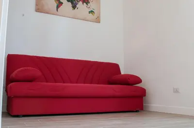 a red couch in the corner of a room at St. Peter Vatican Apartment in Rome