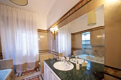 a bathroom with a sink and a tub at Carducci Luxury Apartment in Rome
