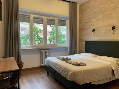 a bedroom with a bed with two towels on it at Luciano Licia Guest House in Rome