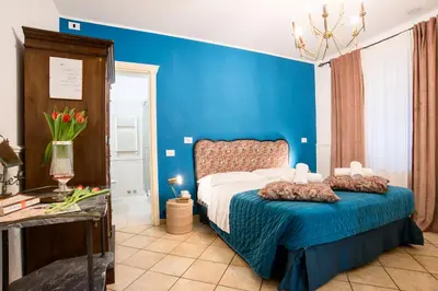 a blue bedroom with a bed and a blue wall at Colosseum B in Rome