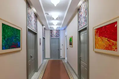 a hallway with doors and paintings on the walls at Albergo Etico Roma in Rome