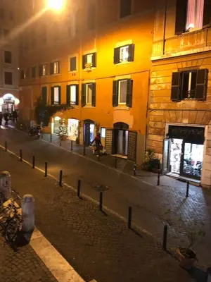 an empty street at night with a yellow building at 