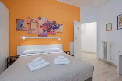 a bedroom with a bed with two towels on it at Damiani & Sister Guesthouse in Rome