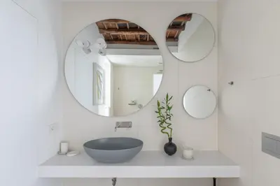 a bathroom with a blue sink and two mirrors at iFlat Vatican High-End Apartment in Rome