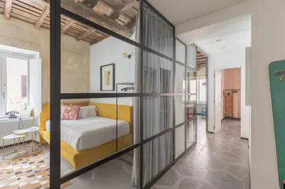 a bedroom with a bed and a tub in a room at iFlat Vatican High-End Apartment in Rome