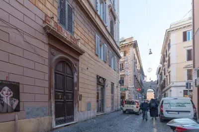 a city street with buildings and people walking down the street at iFlat Vatican High-End Apartment in Rome