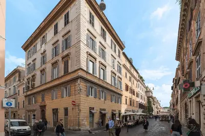 a large building on a city street with people walking around at iFlat Vatican High-End Apartment in Rome