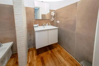 a bathroom with a white sink and a mirror at Trastevere Glasshouse in Rome