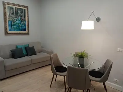 a living room with a glass table and a couch at Fontana Di Trevi - Central Apartment in Rome in Rome
