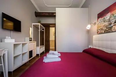 a room with pink carpet and white furniture and a mirror at Dulcis In Fundo b&b in Rome
