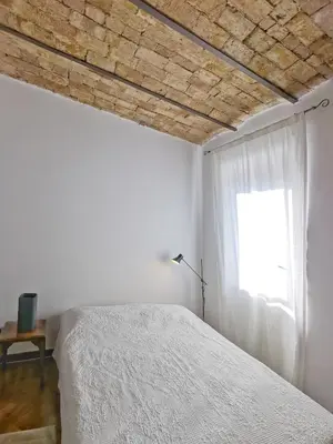 a bedroom with a white bed and a window at Borgo Pio San Pietro Apartment in Rome