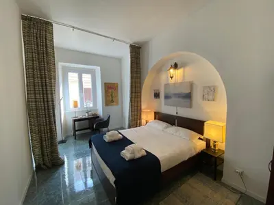 a bedroom with a bed with two towels on it at Pimpinella in Rome