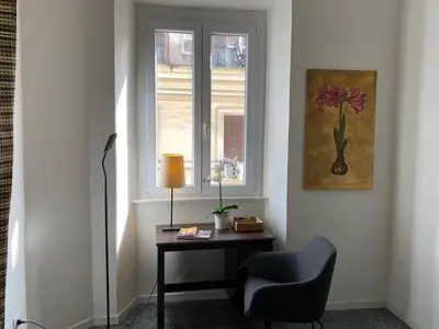 a room with a desk and a chair and a window at Pimpinella in Rome