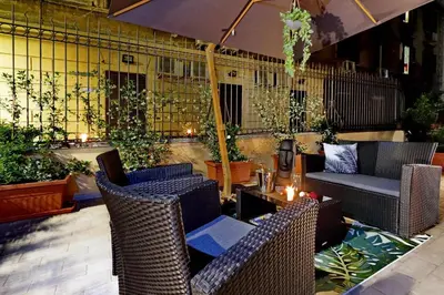 a patio with wicker chairs and a table at Termini Terrace in Rome