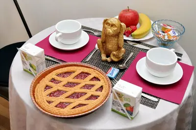 a table topped with a waffle and a basket of fruit at Termini Terrace in Rome