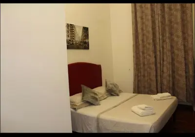 a bedroom with a bed with towels on it at affittacamere sereno in Rome