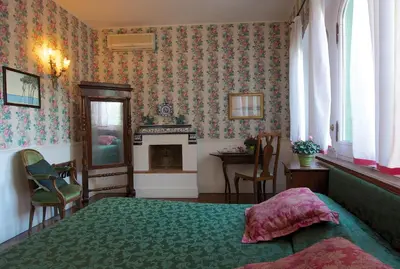 a bedroom with a bed and a fireplace at Guest House Arco Dei Tolomei in Rome