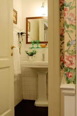 a bathroom with a sink and a mirror at Guest House Arco Dei Tolomei in Rome