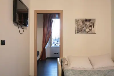 a living room with a bed and a window at House Monti 1875 in Rome