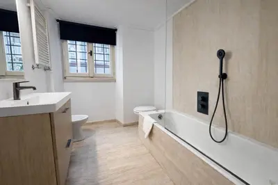 a bathroom with a tub and a toilet and a sink at La Pigna Boutique Apartment in Rome