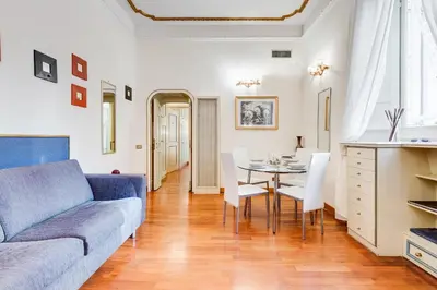 a living room with a couch and a table at Elegant Apartment Rome in Rome