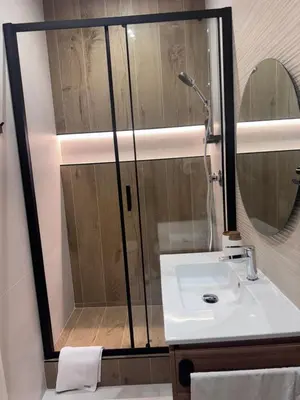 a bathroom with a shower and a white sink at Living in Rome