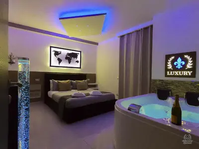 a bedroom with a bed and a tub in it at Giglio Luxury Apartment - Romantic Jacuzzi in Rome