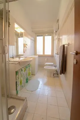 a bathroom with two sinks and two toilets at GiuMa Roma Vatican Apartment in Rome
