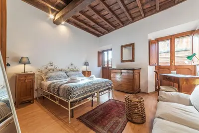 a bedroom with a bed and a couch at GuestHost - Montecitorio & Pantheon Stylish Flat in Rome